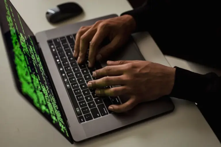 Hände tippen auf einer Laptop-Tastatur